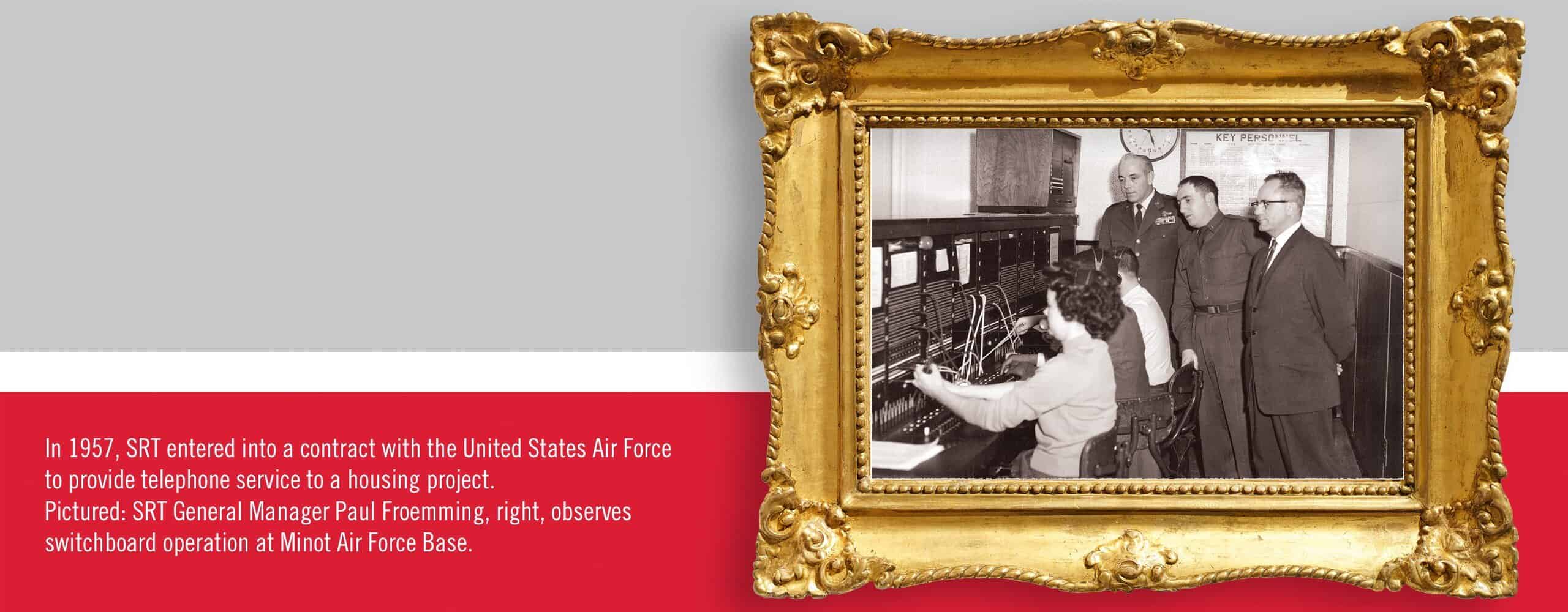 SRT employees demonstrate a telecommunications power panel used in the 1960s.